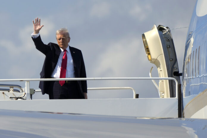 President Donald Trump waves as he boards Air Force One at Palm Beach International Airport in West Palm Beach, Fla., Sunday, Feb. 9, 2025. (AP Photo/Ben Curtis)