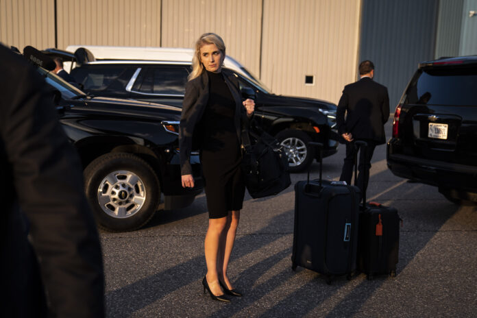 Manchester, NH - April 27 : Assistant Natalie Harp follows Former President Donald Trump as he boards his airplane, known as 