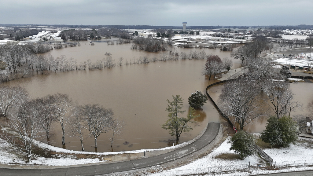 A high-rising Barren River flows through Bowling Green, Ky., Sunday, Feb. 16, 2025, after heavy rainfall beginning early Saturday morning brought nearly five inches of rain and snowfall to Warren County. (Jack Dobbs/Daily News via AP)