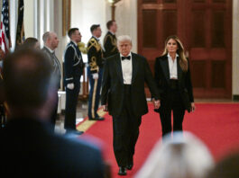 President Donald Trump and first lady Melania Trump arrive at the National Governors Association dinner and reception in the East Room of the White House Saturday, Feb. 22, 2025, in Washington. (Pool via AP)