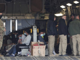 Migrants sit on a military aircraft at Fort Bliss in El Paso, Tx., Thursday, Jan. 30, 2025, awaiting their deportation to Guatemala. (AP Photo/Christian Chavez)