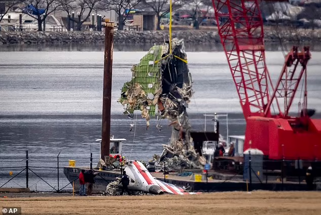 A deadly collision between a helicopter and an American Airlines regional jet killed 67 people last week (pictured: the wreckage being removed from the Potomac River)

