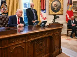 Donald Trump, alongside Secretary of Commerce nominee Howard Lutnick (center) and Rupert Murdoch (right), speaks to the press after signing an executive order to create a US sovereign wealth fund, in the Oval Office of the White House on Monday. AFP via Getty Images