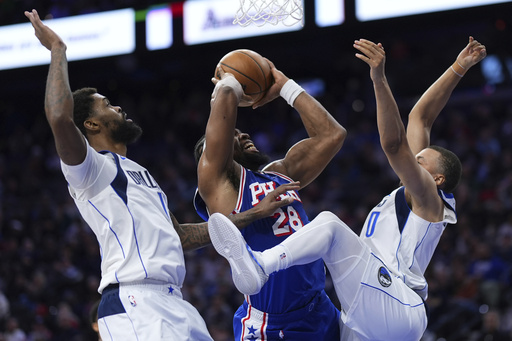 Joel Embiid records a triple-double in his first game in a month, leading the Sixers to a narrow 118-116 victory over the Mavericks.