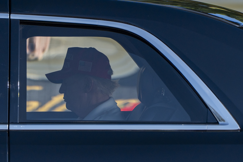 President Donald Trump rides in his limousine to the Trump International Golf Club, Saturday, March 1, 2025, in West Palm Beach, Fla. (AP Photo/Alex Brandon)