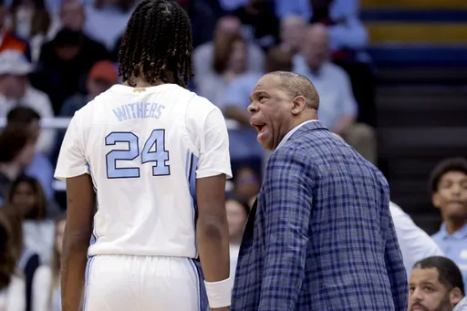 North Carolina head coach Hubert Davis has some words for forward Jae'Lyn Withers (24) during the second half of an NCAA college basketball game against Virginia, Saturday, Feb. 22, 2025, in Chapel Hill, N.C. (AP Photo/Chris Seward)